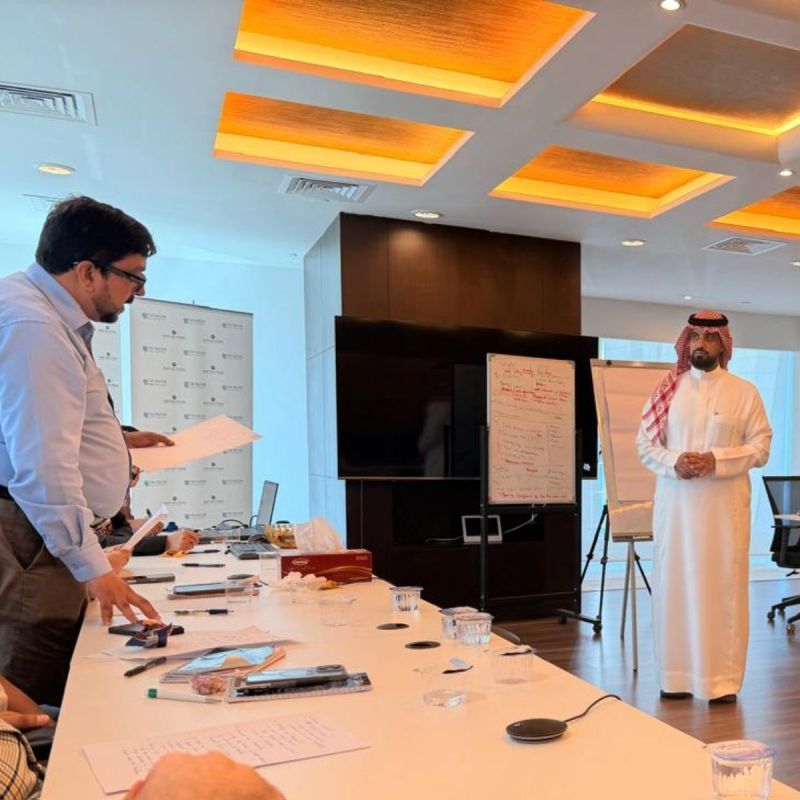 Managers and team leads in discussion during a workshop session.
